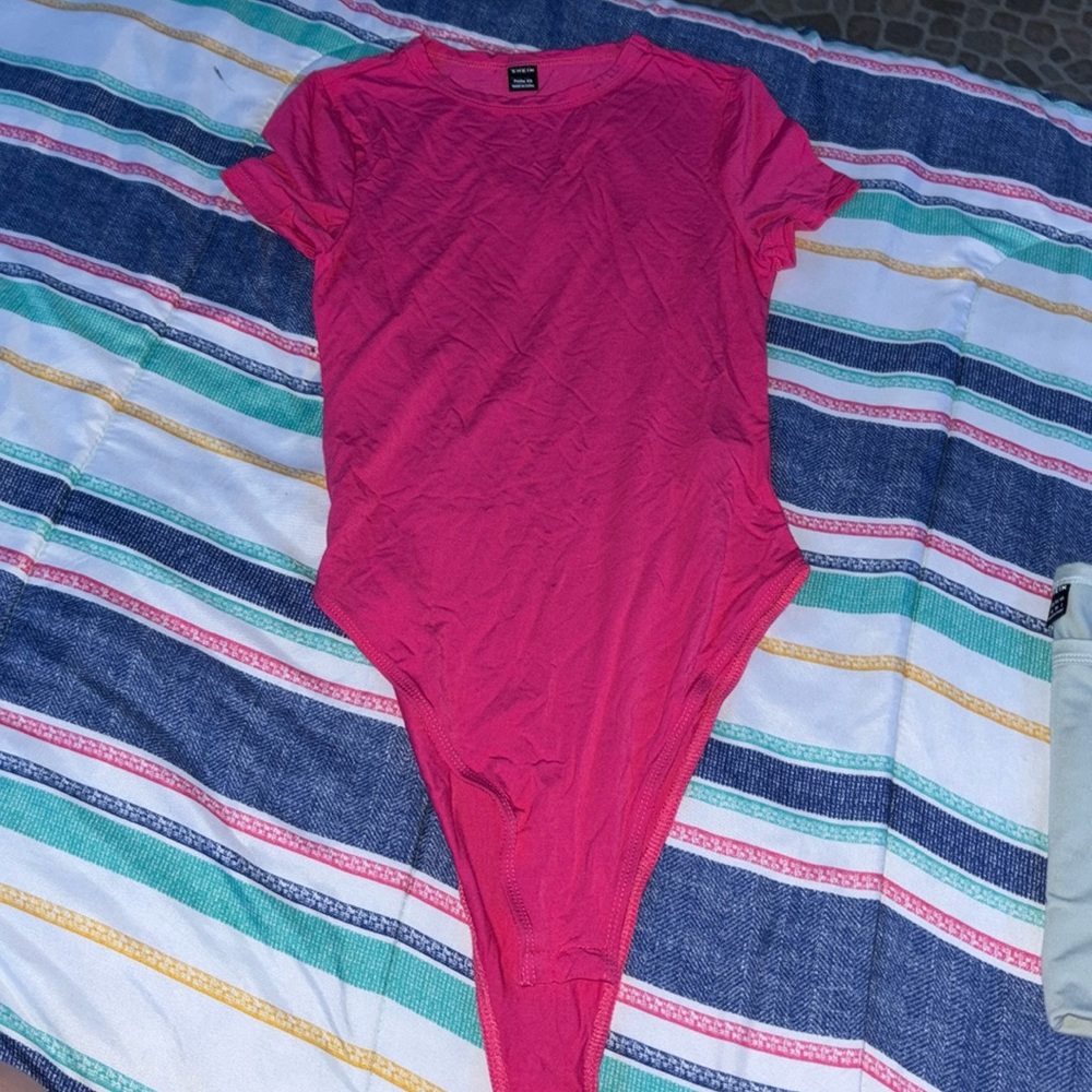 I am selling a body suit. Pink. XS